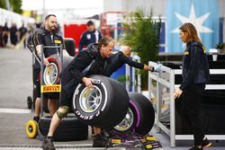 Pirelli personnel unload tyres in the paddock