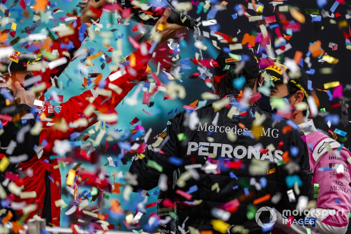 Sebastian Vettel, Ferrari, 3rd position, and Sergio Perez, Racing Point, 2nd position, pour Champagne over Lewis Hamilton, Mercedes-AMG F1, 1st position, on the podium