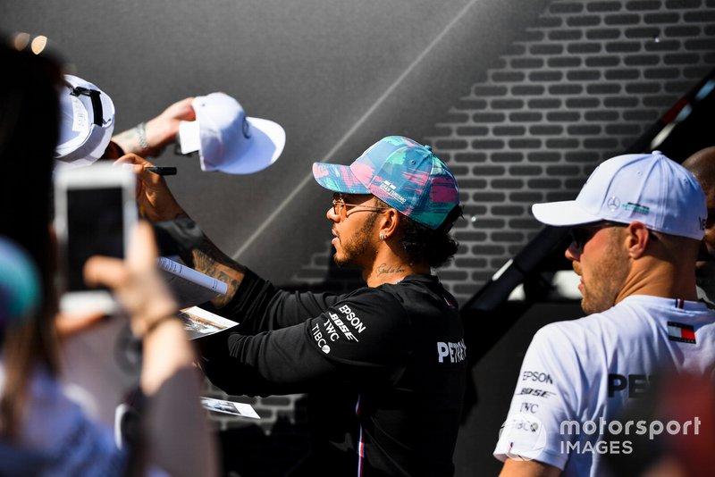Lewis Hamilton, Mercedes AMG F1 and Valtteri Bottas, Mercedes AMG F1 sign autographs for fans