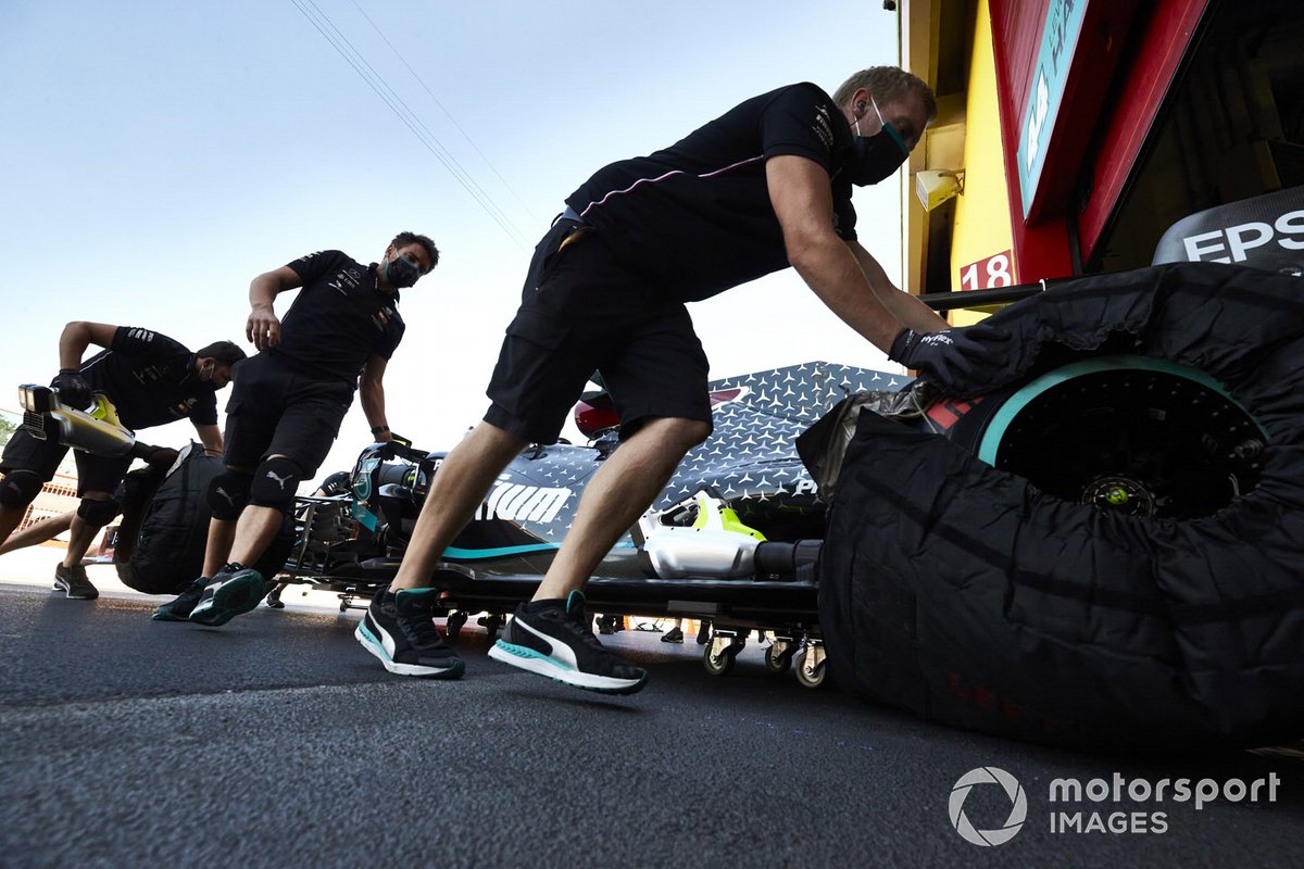 Lewis Hamilton, Mercedes F1 W11, is returned to the garage