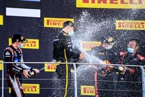 Christian Lundgaard, ART Grand Prix, 1st position, Louis Deletraz, Charouz Racing System, 2nd position, and Juri Vips, Dams, 3rd position, celebrate with Champagne on the podium