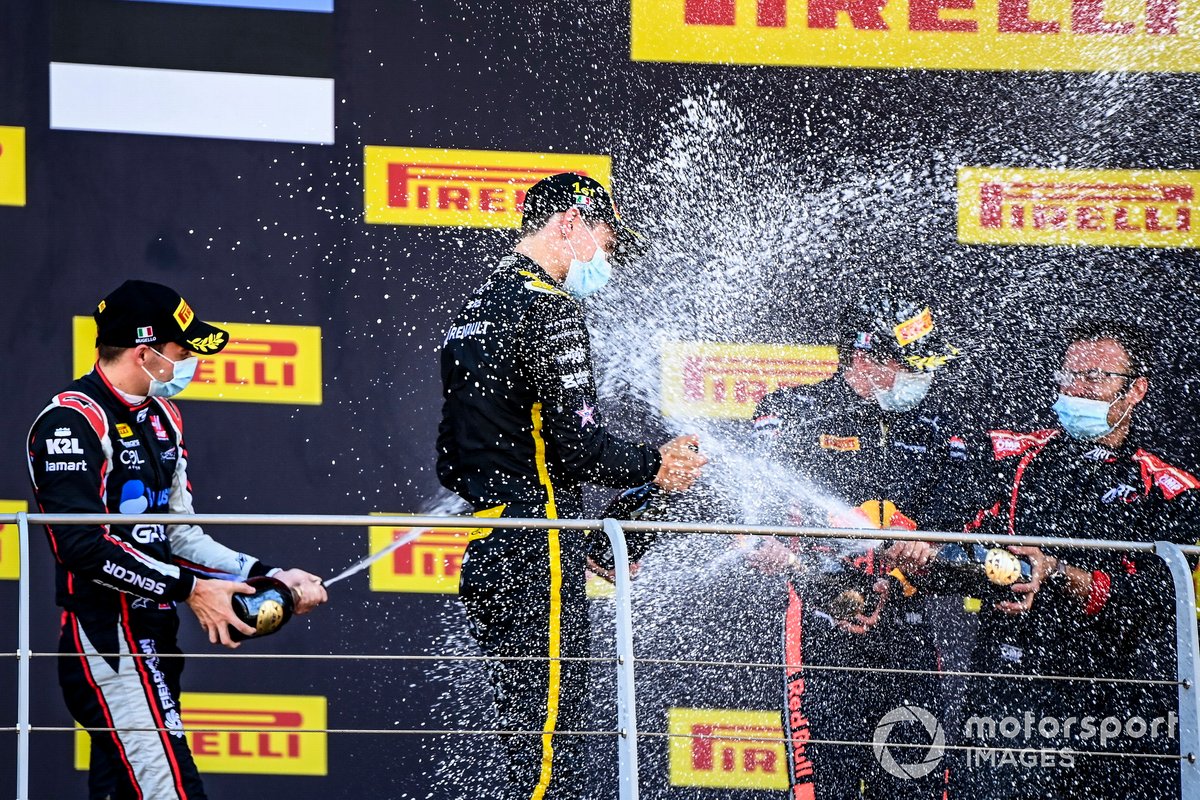 Christian Lundgaard, ART Grand Prix, 1st position, Louis Deletraz, Charouz Racing System, 2nd position, and Juri Vips, Dams, 3rd position, celebrate with Champagne on the podium