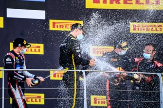 Christian Lundgaard, ART Grand Prix, 1st position, Louis Deletraz, Charouz Racing System, 2nd position, and Juri Vips, Dams, 3rd position, celebrate with Champagne on the podium