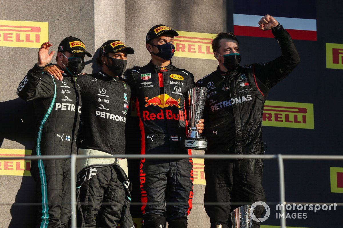 Valtteri Bottas, Mercedes-AMG F1, 2nd position, Lewis Hamilton, Mercedes-AMG F1, 1st position, Alex Albon, Red Bull Racing, 3rd position, and the Mercedes trophy delegate on the podium