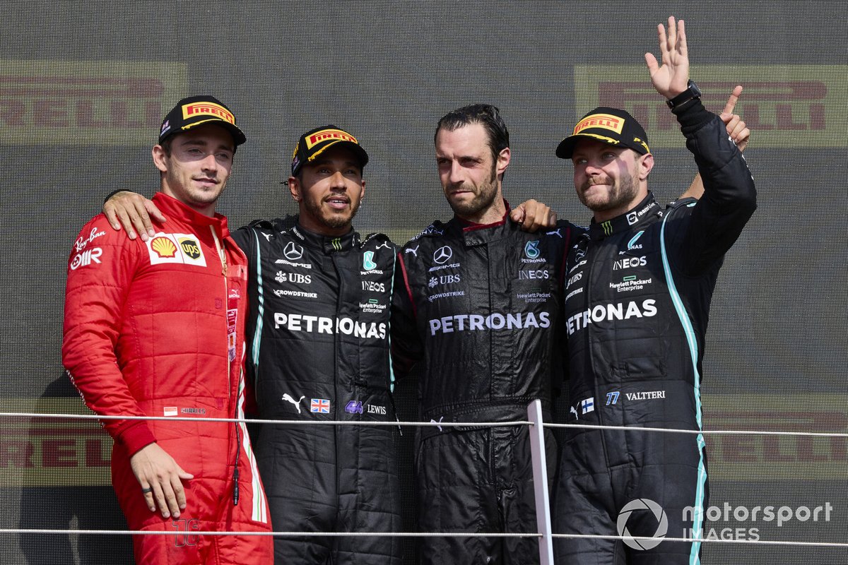 Charles Leclerc, Ferrari, 2nd position, Lewis Hamilton, Mercedes, 1st position, the Mercedes trophy delegate and Valtteri Bottas, Mercedes, 3rd position, on the podium