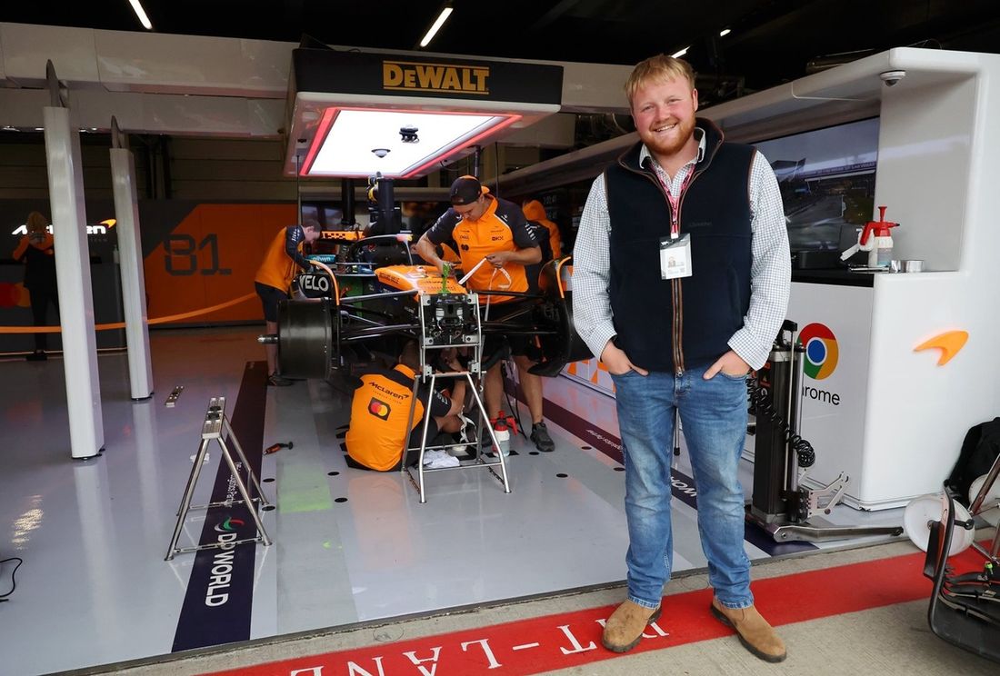 Kaleb Cooper poses for a photo outside the McLaren garage 