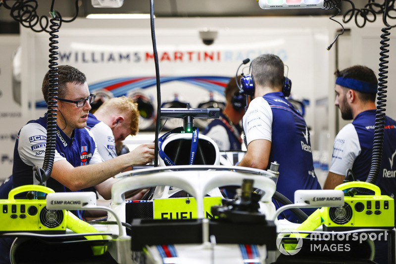 Engineers work on the car of Lance Stroll, Williams FW41