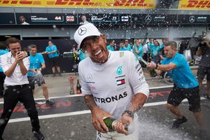 Lewis Hamilton, Mercedes AMG F1, sprays champagne in celebration of victory