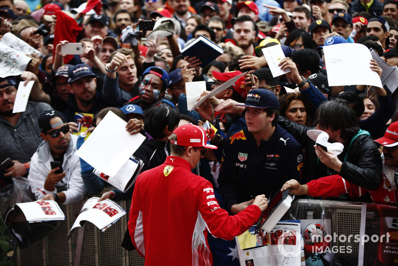 Kimi Raikkonen, Ferrari, signs an autograph