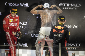 Sebastian Vettel, Ferrari, Lewis Hamilton, Mercedes AMG F1 and Max Verstappen, Red Bull Racing celebrate on the podium with the champagne