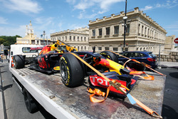 The damaged Red Bull Racing RB12 of Daniel Ricciardo, is recovered back to the pits on the back of a truck