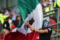 A masked fan with a Mexican flag