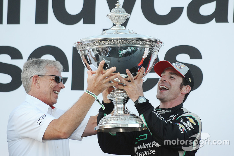 CEO of Verizon Lowell C. McAdam hands the IndyCar championship trophy to Simon Pagenaud, Team Penske Chevrolet