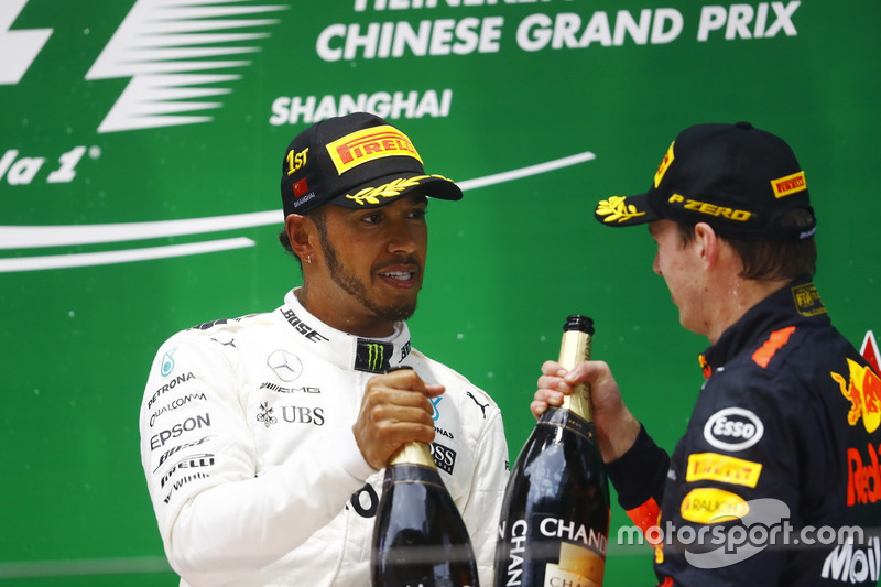 Race winner Lewis Hamilton, Mercedes AMG, and Max Verstappen, Red Bull Racing, celebrate with Champagne on the podium