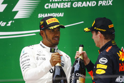 Race winner Lewis Hamilton, Mercedes AMG, and Max Verstappen, Red Bull Racing, celebrate with Champagne on the podium