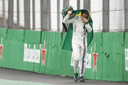 Felipe Massa, Williams, walks back to the garage in tears carrying a Brazilian flag afer crashing