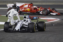 Sebastian Vettel, Ferrari SF70H, passes Lance Stroll, Williams FW40, as he climbs out of his damaged car