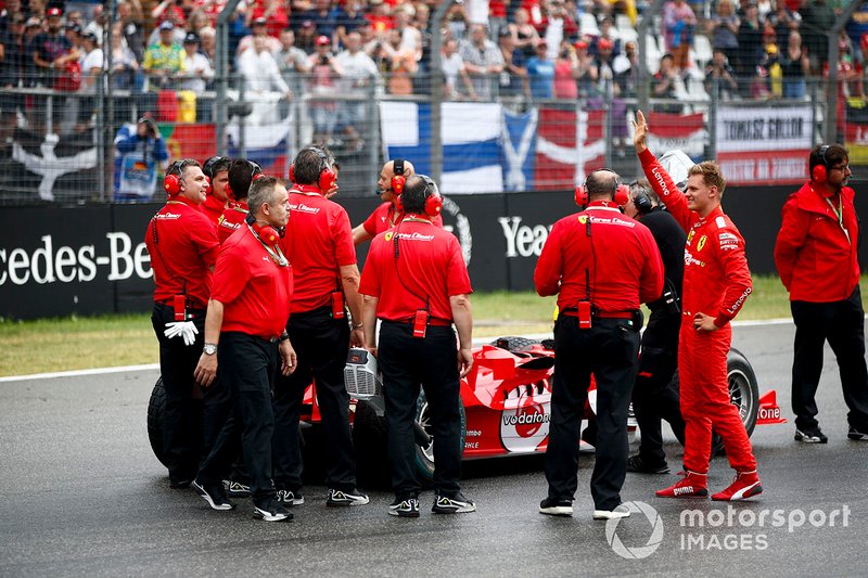 Mecánicos con Mick Schumacher y el Ferrari F2004 conducido por su padre Michael Schumacher