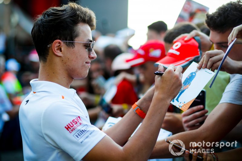 Lando Norris, McLaren signs an autograph for a fan