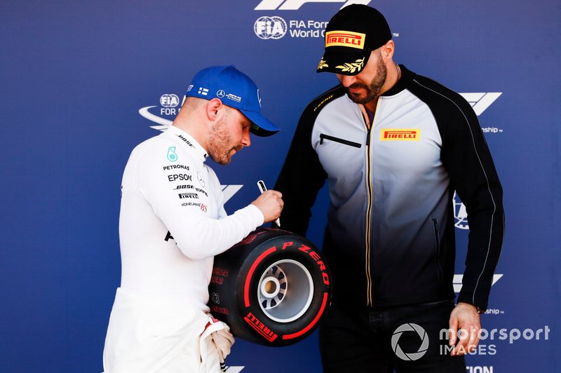 WWE wrestler Cesaro presents Valtteri Bottas, Mercedes AMG F1, with his Pirelli Pole Position award