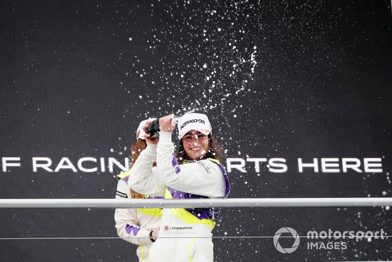 Jamie Chadwick sprays the champagne on the podium