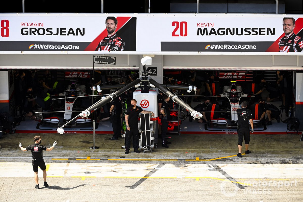 Romain Grosjean, Haas VF-20, and Kevin Magnussen, Haas VF-20, in the garage