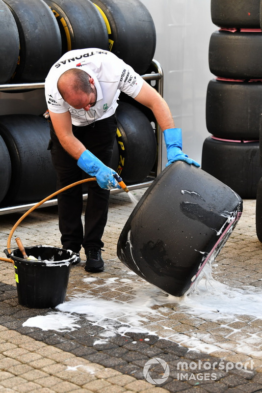 Mercedes AMG F1 mechanic washes Pirelli tyres