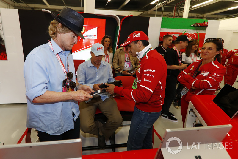 Owen Wilson and Woody Harrelson receive a tour of the Ferrari garage from Sergio Marchionne, Chief E