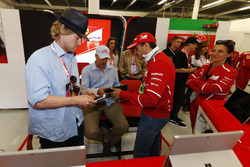 Owen Wilson and Woody Harrelson receive a tour of the Ferrari garage from Sergio Marchionne, Chief Executive Officer, Fiat Chrysler and Chairman, Ferrari. Gene