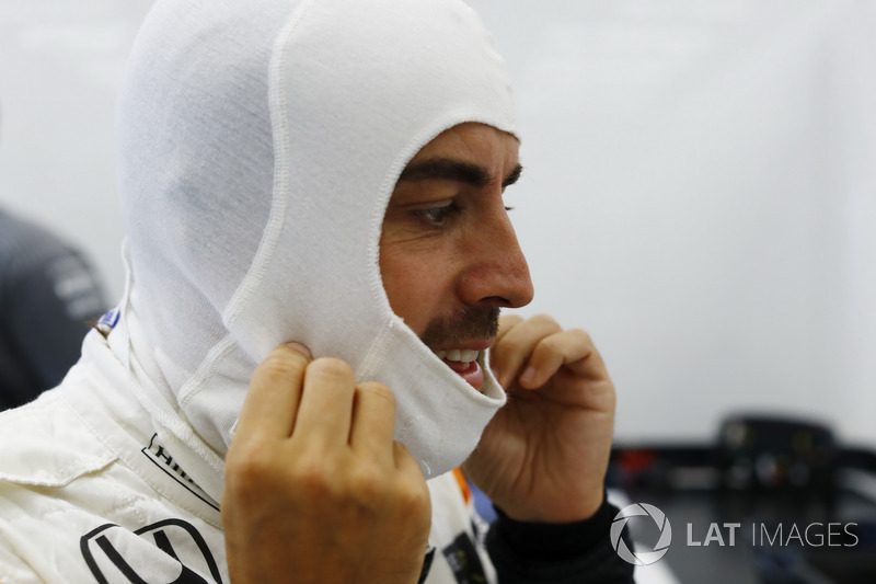 Fernando Alonso, McLaren, adjusts his balaclava before qualifying
