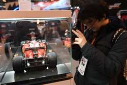 A fan takes a picture of an Amalgam Ferrari model