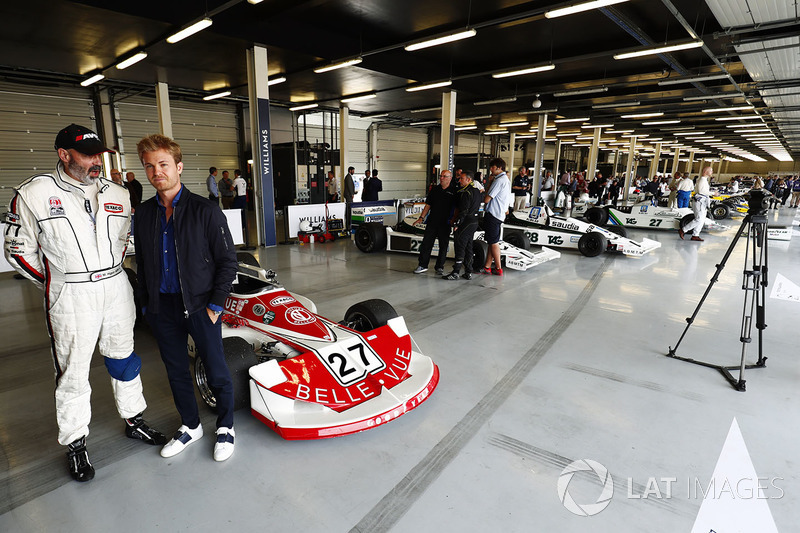 Nico Rosberg, stands in front of a 1977 March 761, raced in period by Patrick Neve