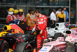 Sebastian Vettel, Ferrari, examines a Red Bull Racing RB13 in parc ferme