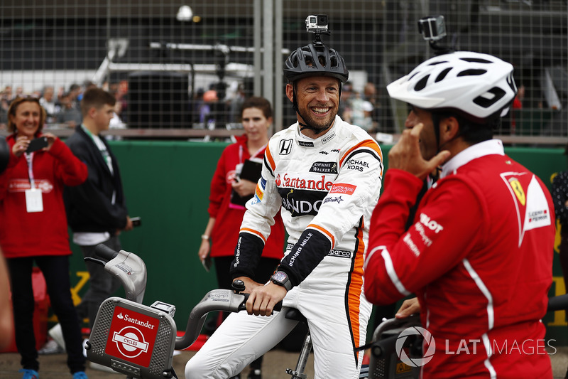 Jenson Button, McLaren, Marc Gene of Ferrari sit astride bicycles