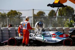 Lance Stroll, Williams FW41, climbs out of his car and is assisted by marshals after spinning into the gravel