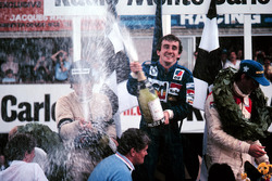 Podium: race winner Alain Prost, second place Nelson Piquet, third place John Watson