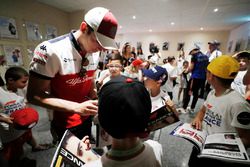 Charles Leclerc, Sauber, signs autographs for the grid kids