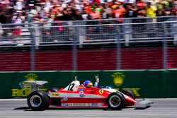 Jacques Villeneuve drives the Ferrari 312T3 raced by his father Gilles Villeneuve on a parade lap