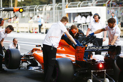 McLaren engineers return Fernando Alonso, McLaren MCL33 Renault, to the garage