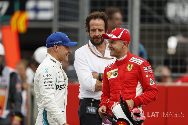 Pole sitter Sebastian Vettel, Ferrari, talks to Valtteri Bottas, Mercedes AMG F1