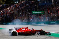 Sebastian Vettel, Ferrari SF70H, performs doughnuts as he returns to the pits after winning the race