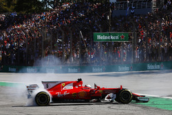 Sebastian Vettel, Ferrari SF70H, performs doughnuts as he returns to the pits after winning the race
