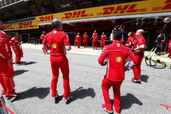 Ferrari team members limber up before the race