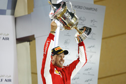 Sebastian Vettel, Ferrari, 1st position, lifts his trophy on the podium