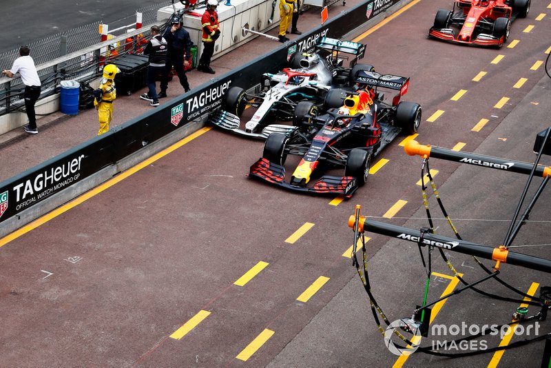 Max Verstappen, Red Bull Racing RB15, and Valtteri Bottas, Mercedes AMG W10, battle in the pit lane