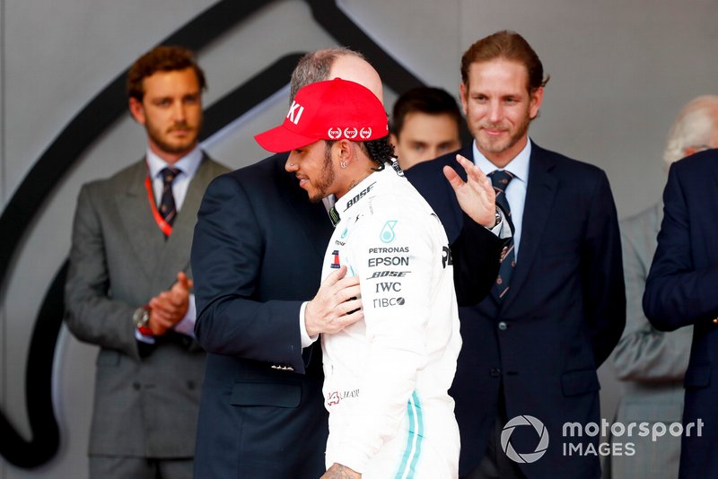 Lewis Hamilton, Mercedes AMG F1, 1st position, is greeted on the podium by Prince Albert II of Monaco
