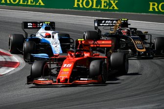 Charles Leclerc, Ferrari SF90, leads Kevin Magnussen, Haas F1 Team VF-19, and Robert Kubica, Williams FW42