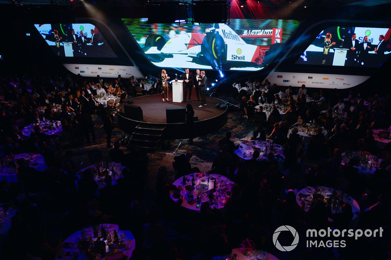 Mika Hakkinen receives a Gregor Grant Award from Martin Brundle on stage