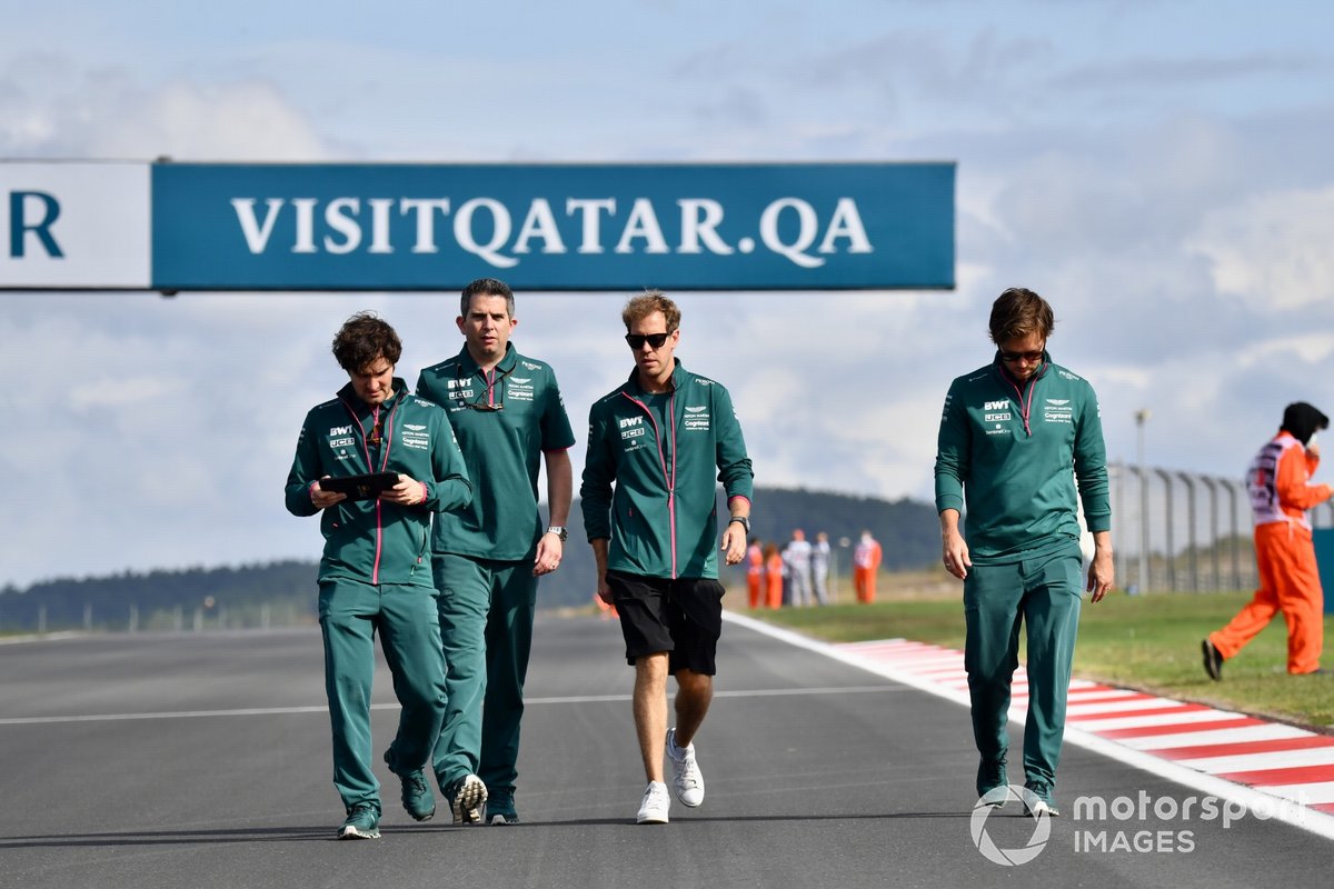 Sebastian Vettel, Aston Martin, walks the track with member so his team