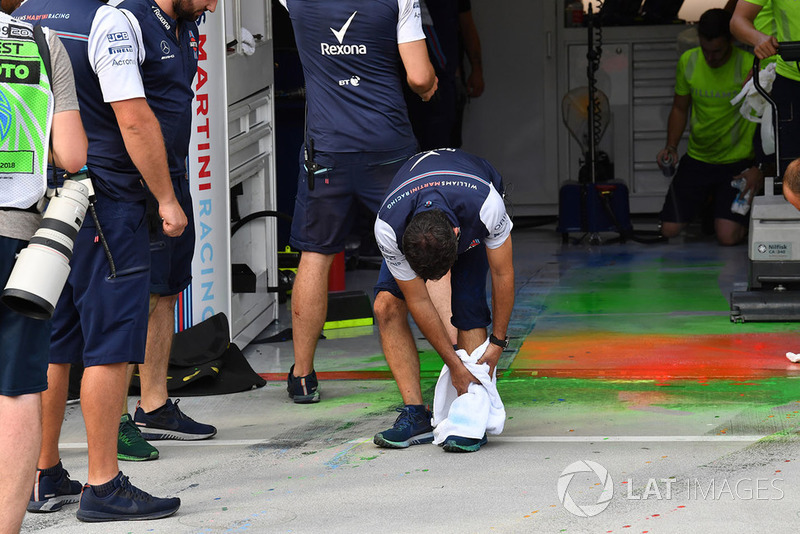 Williams mechanics clean aero paint from the garage floor